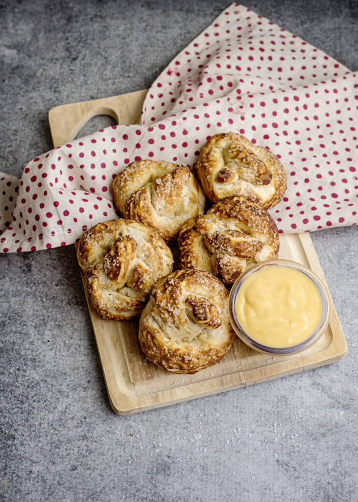 These biscuit pretzels are our favorite easy homemade soft pretzel recipe. They come hot and fresh from the oven with a side of warm, gooey cheese. Life just got better. You can thank me later.